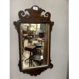 A mid 18th century mahogany wall mirror with fret cut frame and rectangular glass, 63cm high x