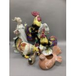 Continental pottery cockerel and hen group perched on a leafy branch, together with two other