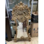 A reproduction 18th century style gilt wall mirror, the 'c' scroll and foliate frame inset with a