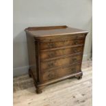 An 18th century style mahogany dressing chest having a baise lined pull slide over four graduated