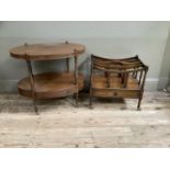 An oval mahogany two tier table, the under tier fitted with a drawer, on slender turned legs with