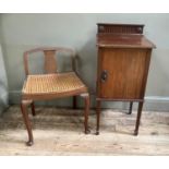 An Edwardian mahogany pot cupboard having a short raised back, single door on square tapered legs,