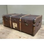 A canvas and wood ribbed trunk with luggage labels, 90cm wide x 34cm high