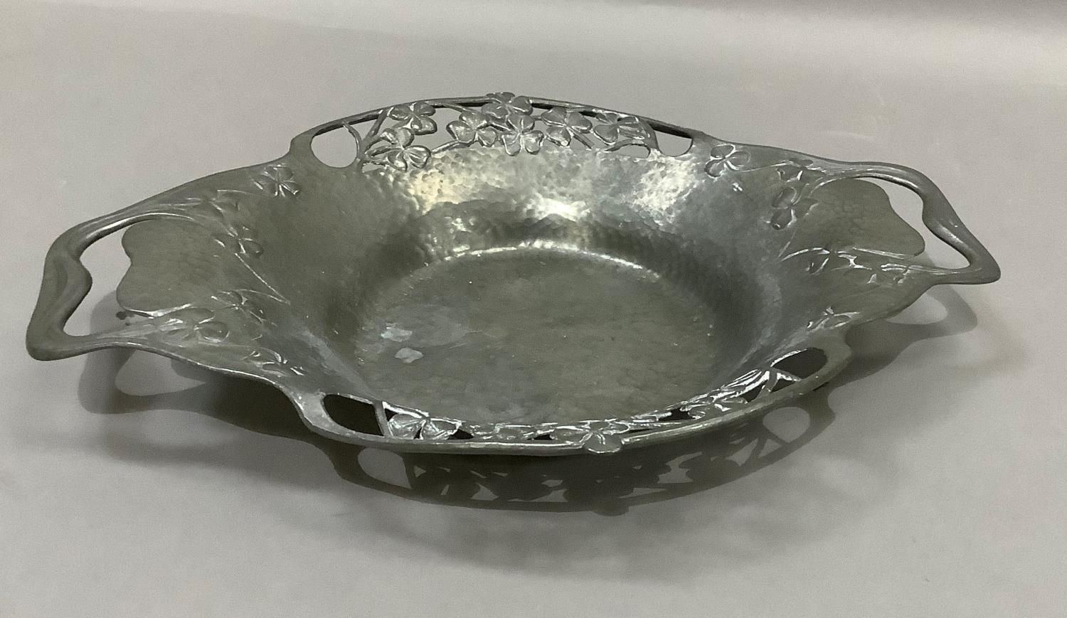 A Tudric pewter two handled dish numbered 0287, the rim pierced with shamrock, 28cm over handles x