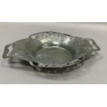 A Tudric pewter two handled dish numbered 0287, the rim pierced with shamrock, 28cm over handles x