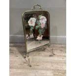 An Edwardian mirrored and brass framed fire screen, the glass painted with roses