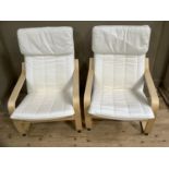 A pair of birch bentwood framed armchairs with cream cotton cushions