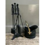 A set of black metal fire irons and stand with matching coal bucket