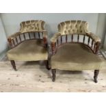 A pair of Victorian mahogany tub chairs having button upholstered back above spindle frame,