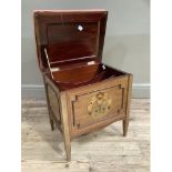 An Edwardian mahogany music stool having an upholstered lift up top, the interior divided for