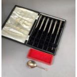 A boxed set of six silver handled tea knives, Sheffield 1953 together with a silver caddy spoon,