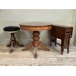 An Edwardian mahogany revolving piano stool, a Sutherland table with railed standards together