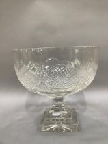 An early 20th century cut glass pedestal fruit bowl cut with panels of diamonds and ovals, panel cut