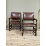 A pair of oak open armchairs, brown hide upholstered with close nailing on turned and square framing