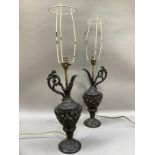 A pair of spelter type ewers cast with cherubs and face masks as lamps, with shades