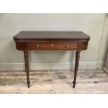 A 19th century mahogany fold over card table, rectangular with rounded corners, the deep frieze with