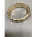 A Stiff hinged bangle in 9ct gold, approximate weight 21g