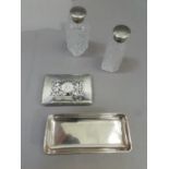 A silver oblong pin tray, a silver trinket box lid, a pair of cut glass silver topped perfume