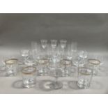 A set of six French glass tumblers with gilt Greek key banding to the rim, a set of seven flutes