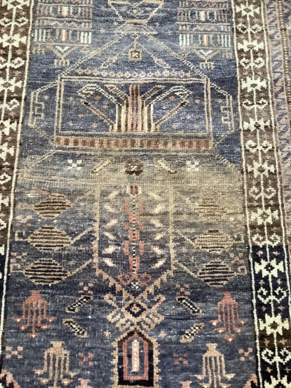 A Middle Eastern rug, the blue field woven with a stylised vase of flowers within multiple - Image 2 of 4