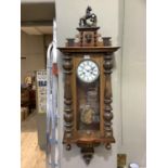 A Victorian walnut wall clock having a white enamel two part dial with black Roman numerals, 8 day