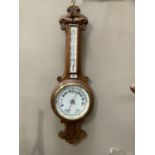 A Victorian oak framed barometer thermometer