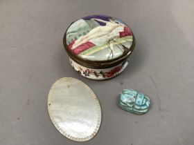 A circular enamel patch box with reclining nude