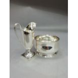 A George V silver helmet cream jug on a square pedestal foot, Sheffield 1934 and a plain circular