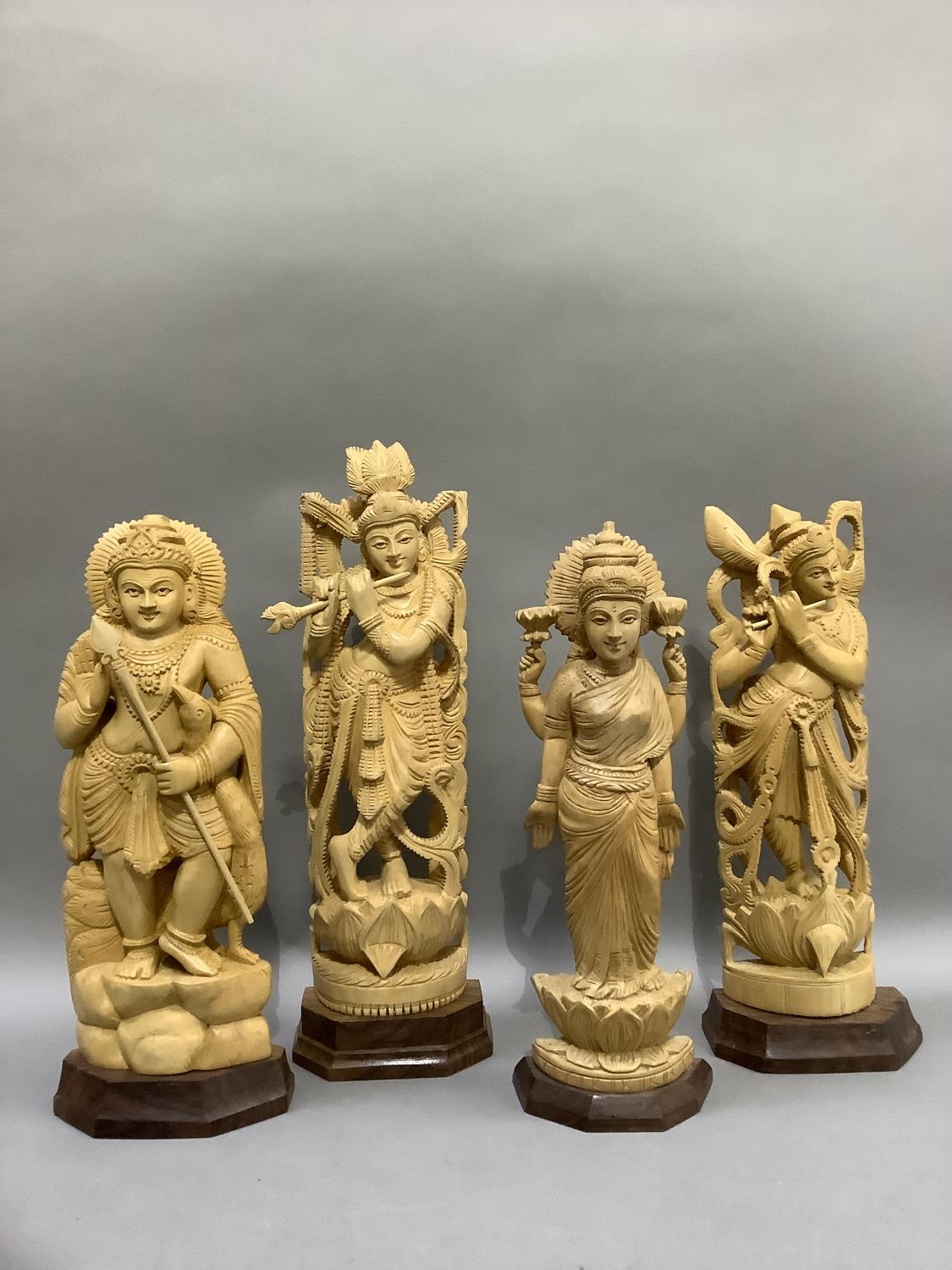 Four Indian carved balsa wood figures of Shiva and three other Indian deities, measuring