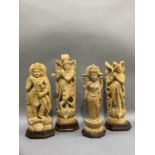 Four Indian carved balsa wood figures of Shiva and three other Indian deities, measuring