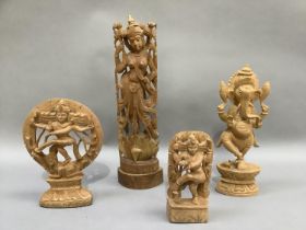 Four Indian balsa wood figures, three of Shiva and the fourth of Ganesh, measuring 34.5cm the