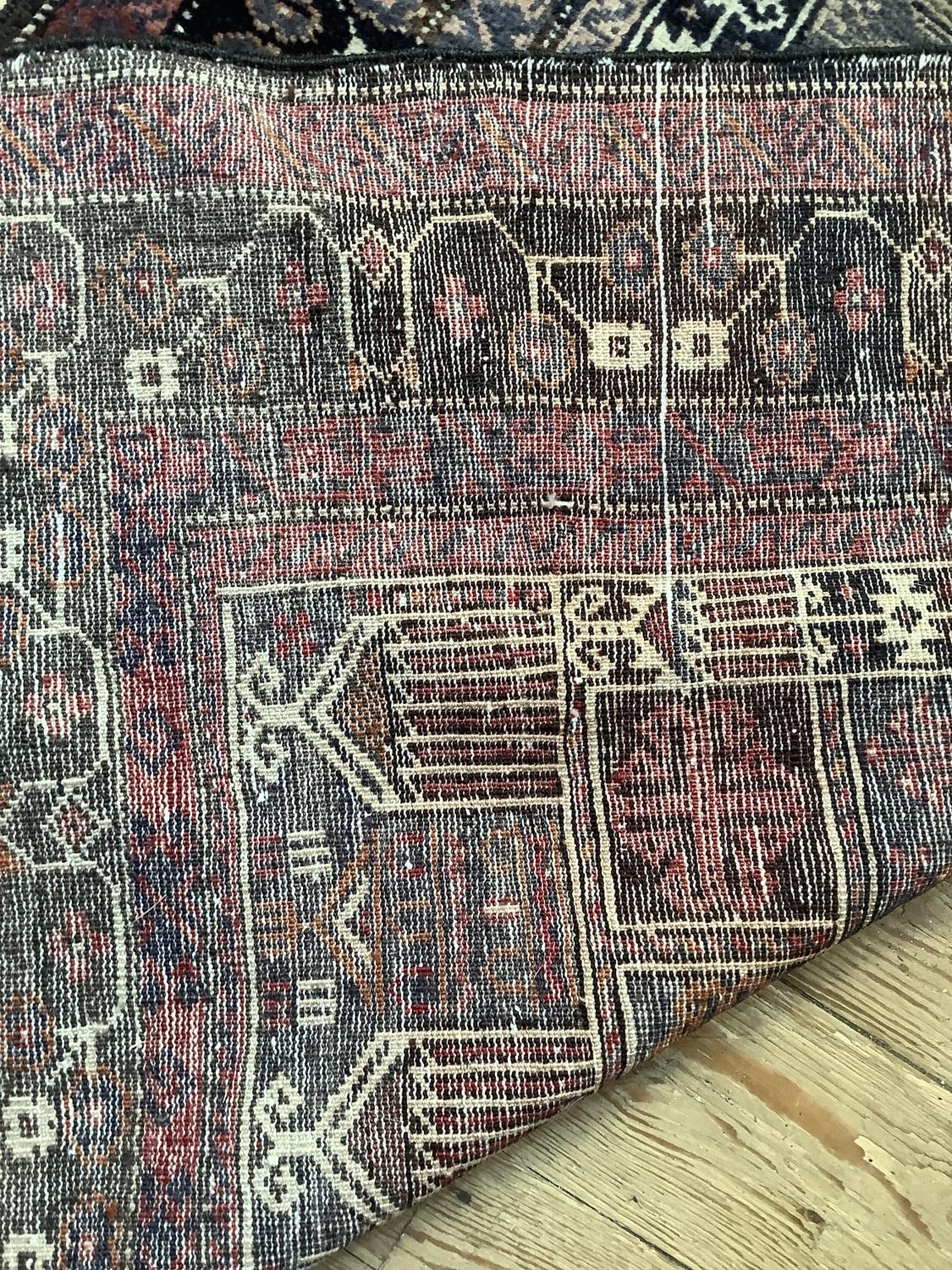 A Middle Eastern rug, the blue field woven with a stylised vase of flowers within multiple - Image 4 of 4