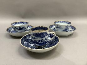 A Chinese export blue and white cup and saucer painted with the willow pattern with gilt