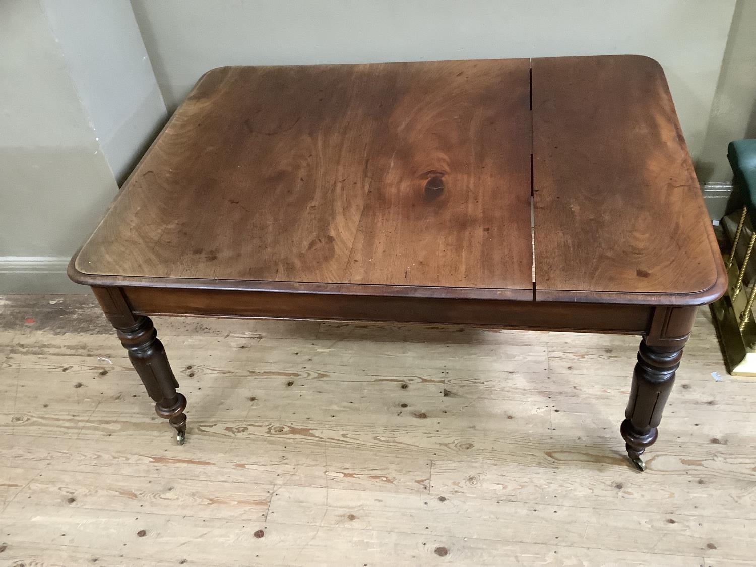 A Victorian mahogany dining table, rectangular with rounded corners, on inverted tulip and turned - Image 4 of 4