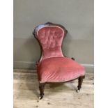 A Victorian walnut chair having an encircling frame, button upholstered back and seat and on