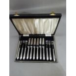 A cased of set of six silver handled fruit knives and forks, Sheffield 1935/36, with jubilee mark