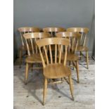 A set of six beech rail back dining chairs on turned legs
