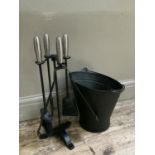 A set of steel handled and black metal fire irons on a stand together with a matching coal bucket