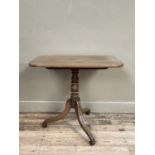 A 19th century mahogany rectangular tilt top table on a turned column and three downswept legs, 82cm