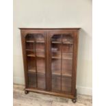 A mahogany book case having two glazed tracery doors and on turned feet, 92cm wide x 27cm deep x