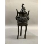 A Chinese bronze two handled korro, the pierced cover with animal finial, pierced gallery to the