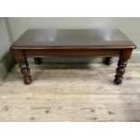 A mahogany finished coffee table, rectangular with plate glass and on turned legs