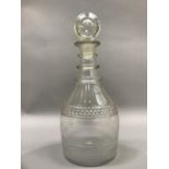 A George III triple collar glass decanter, panel cut and with target stopper, 28cm high