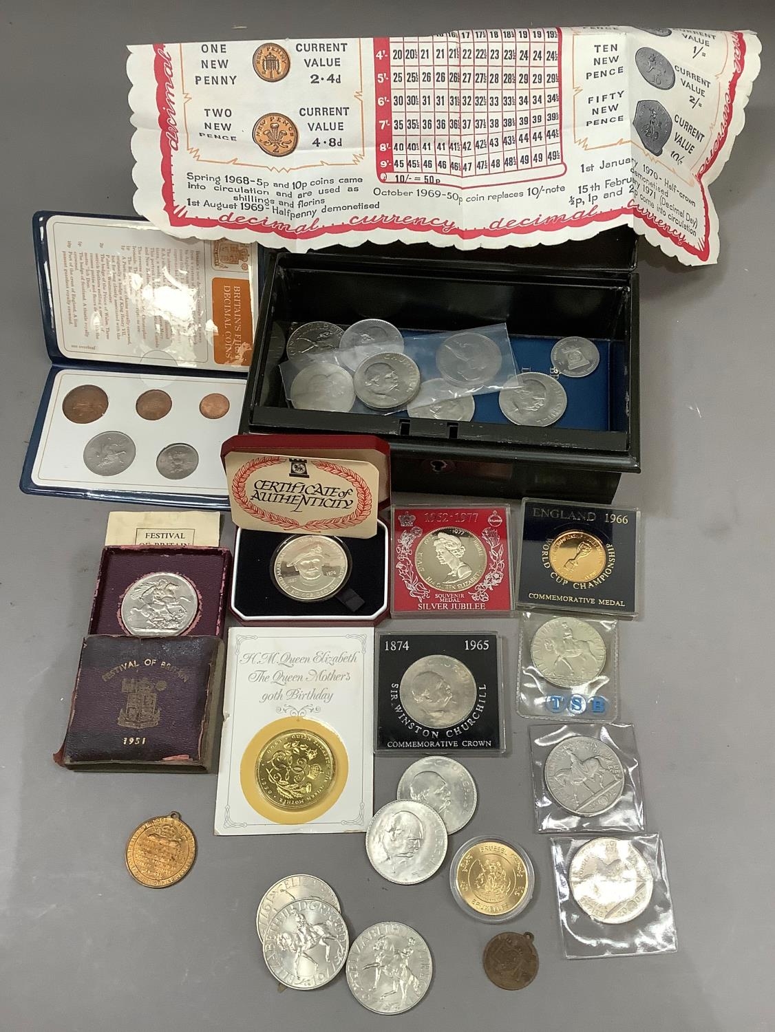 A tin box containing a quantity of UK cupro nickel crowns including 5 x five pound coins, medallions