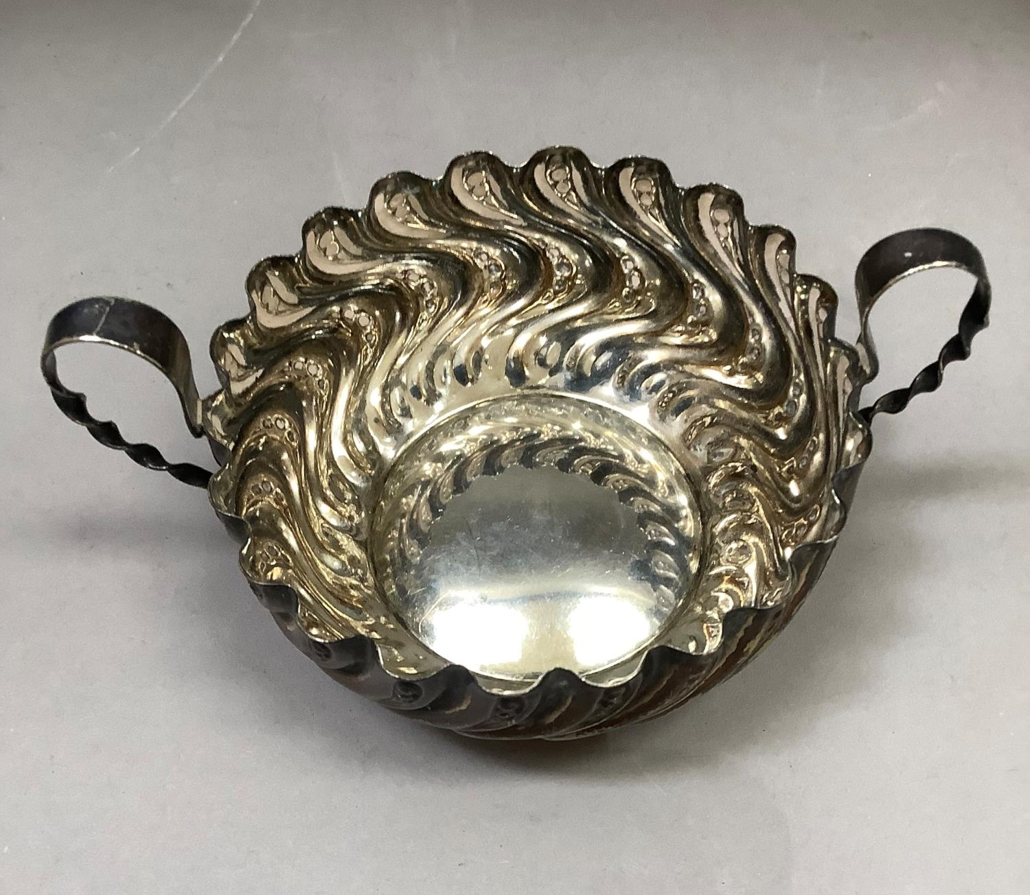 A Victorian silver two handled bon bon dish, circular outline of embossed wrythern stem type