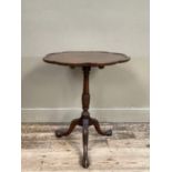 A 19th century mahogany tilt top table having a scalloped top with moulded rim on a reeded and