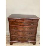 A reproduction mahogany serpentine fronted chest of four long graduated drawers on bracket feet,