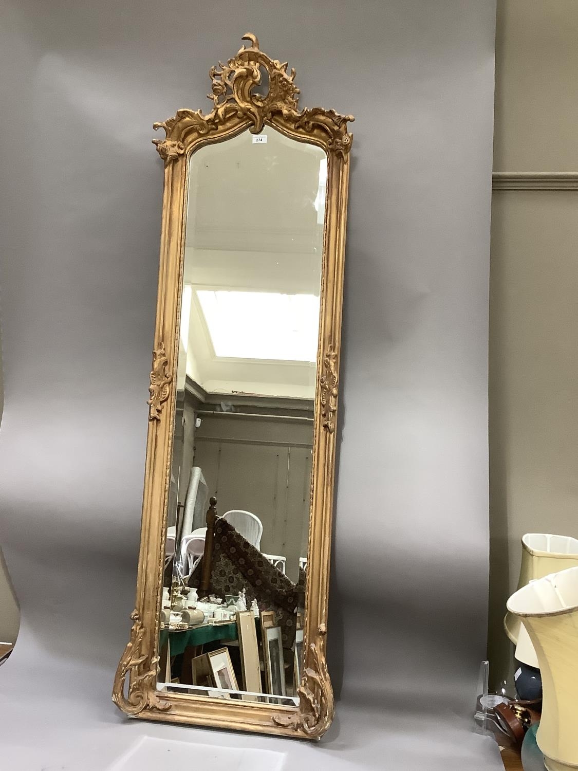 A gilt plaster framed wall mirror of 18th century design having a bevelled glass, 173cm high by 52cm - Image 2 of 2