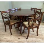 A mahogany extending dining table, twin pedestal, brass paw feet and casters together with a set