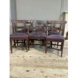 A matched set of eight mahogany early 19th century dining chairs inlaid to the bar back with a